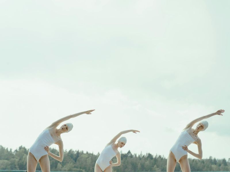 Person maintaining a balanced pose in a calm setting.